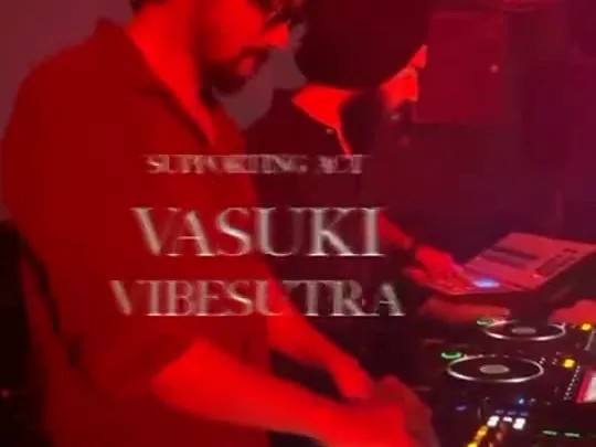 Music Events: a DJ performing at red-lit decks.